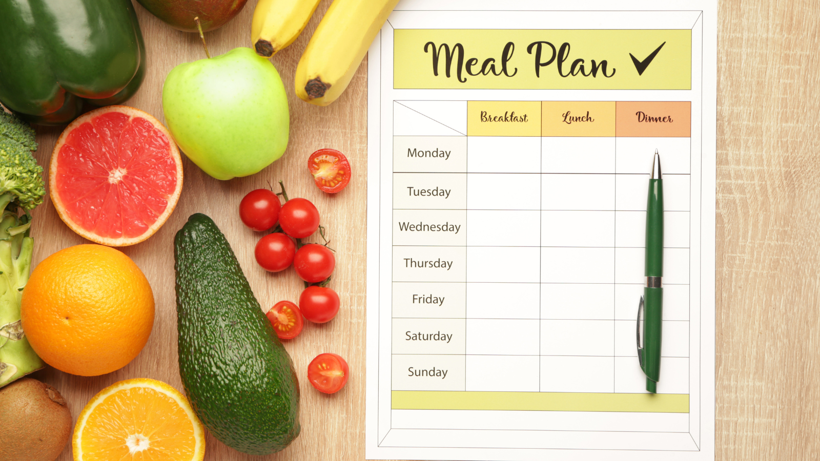 healthy fruits and vegetable next to a meal plan worksheet